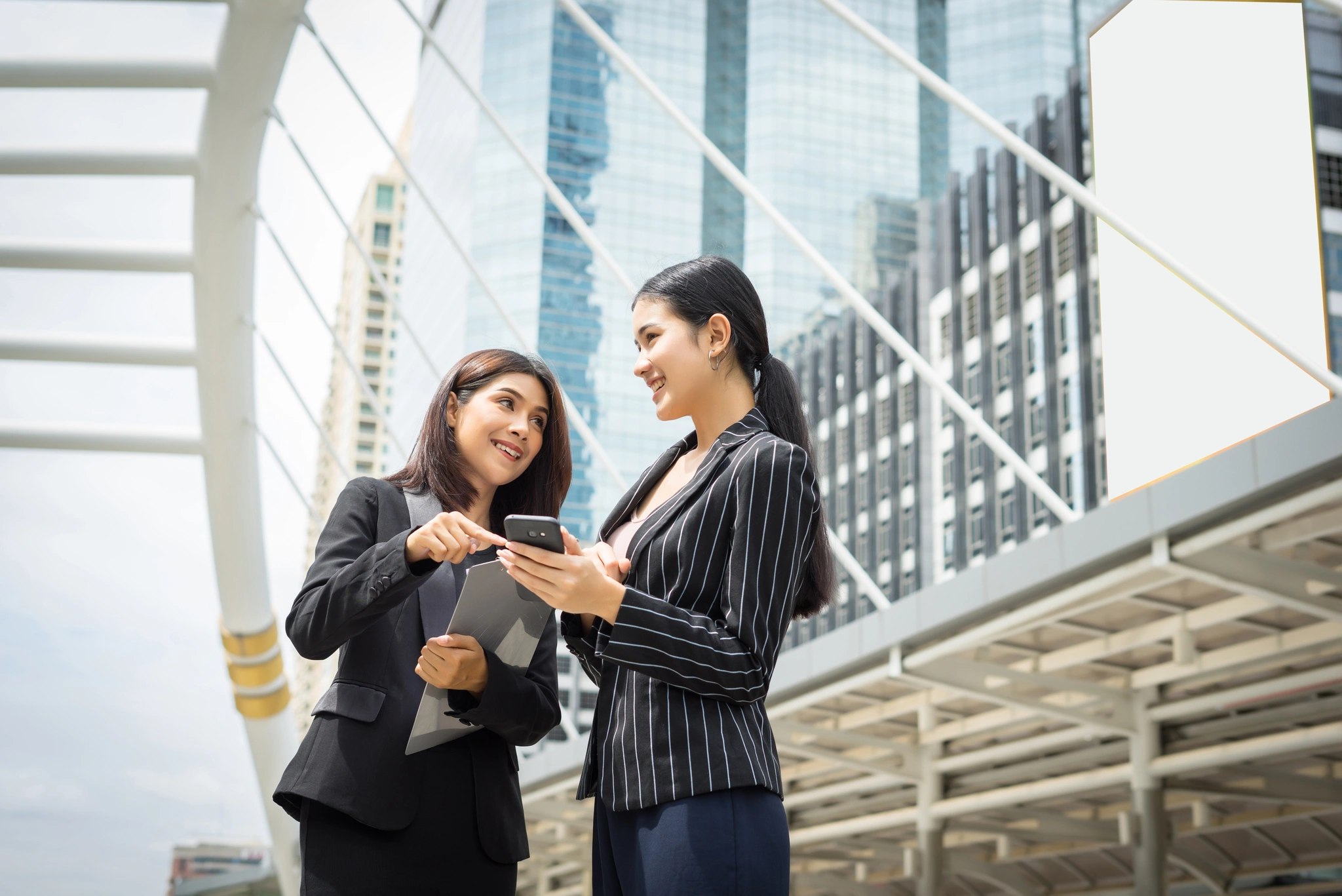 Two colleagues discussing work outside an office